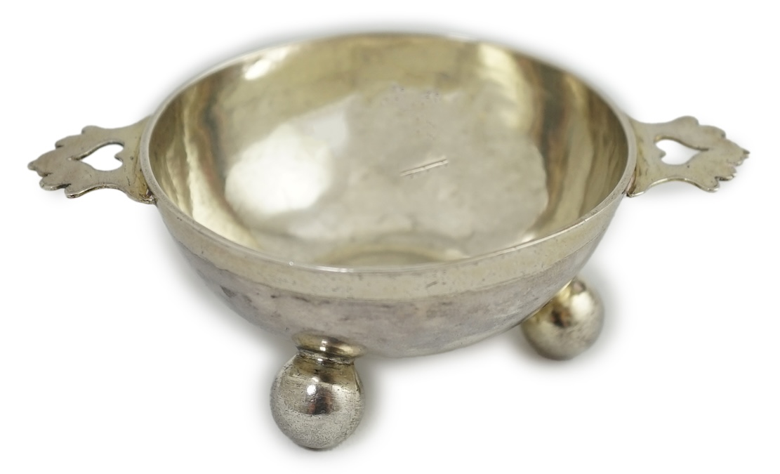 A late 17th century? German Nurnberg silver two handled wine taster, on three ball feet